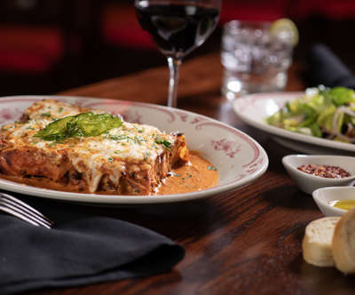 “100 LAYER” LASAGNA BOLOGNESE - Layered with housemade meat sauce, ricotta & mozzarella cheeses, grated Parmesan, finished with vodka sauce